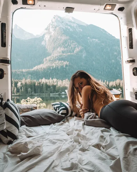 Van Life: a converted campervan interior looking out over a mountain lake